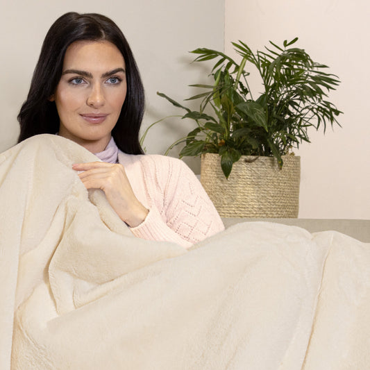 woman under a Dreamland heated throw